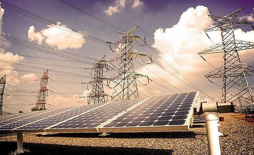 Solar panels beneath power transmission towers
